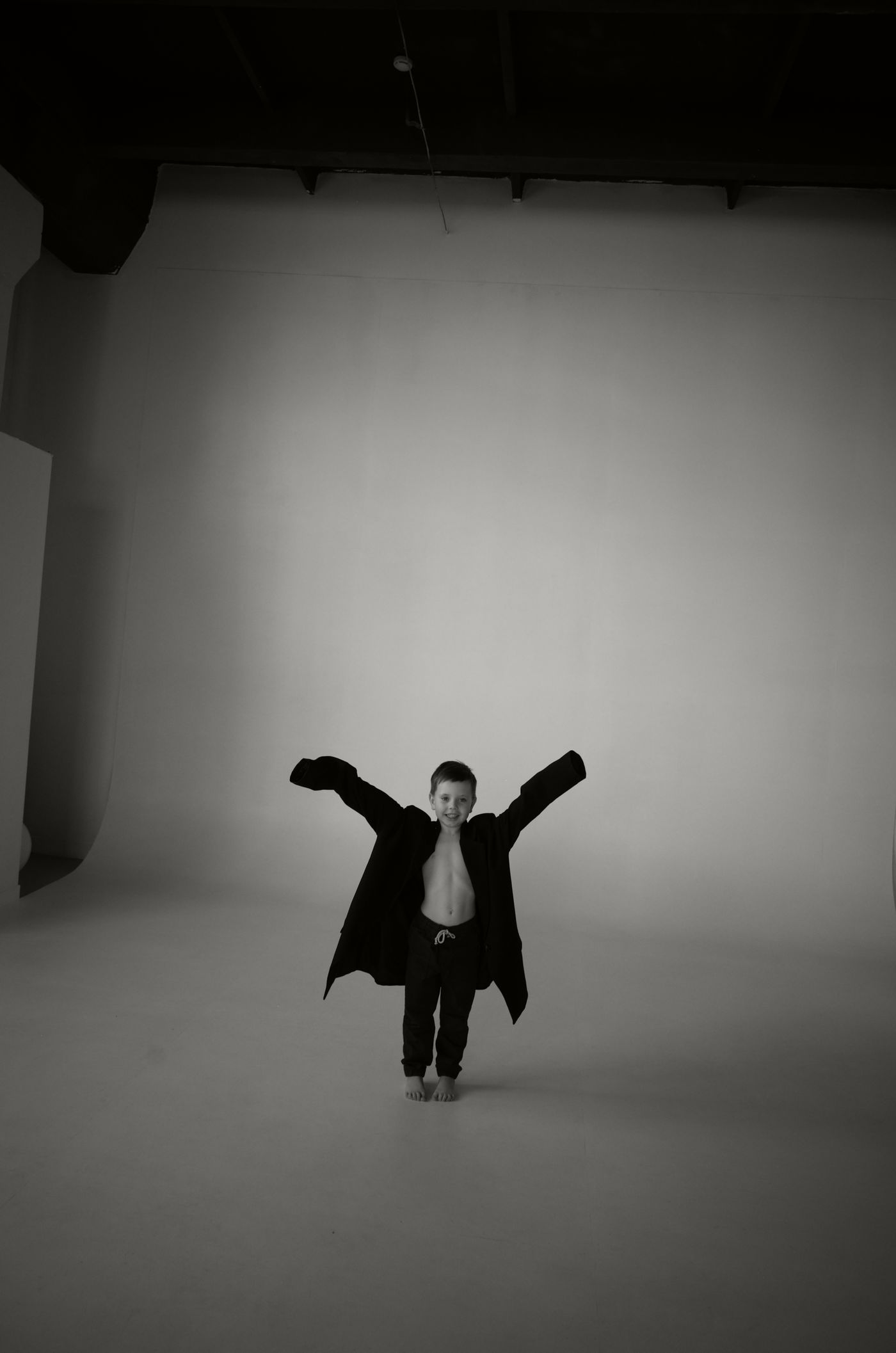 Child wearing an oversized jacket with room to grow
